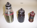 Three examples of plug-in coils for homebrew shortwave receivers. The two on the left are made from vitamin bottles with bases from defunct octal tubes. (Note that the center one has not yet been wound.) The one on the right is a commercial Bakelite form, though I don't know where it was originally sold.