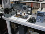 9/97: This is a PC board lashup of a 6DQ5 CW transmitter for 40M. I never transferred the design into a box; in fact, I don't recall writing down the details of the circuit. Worked well, and put out more power than a 6L6 in a similar circuit. The power supply in a galvanized iron box is also home-brew, and put out 440VDC plus AC filament feeds.