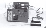1977: After getting some experience with the original COSMAC Elf, I designed and built a much-expanded version, and constructed it on a discarded Xerox 3100 copier platen cover. It worked very well, and I had an OAM paper tape reader interfaced to it.